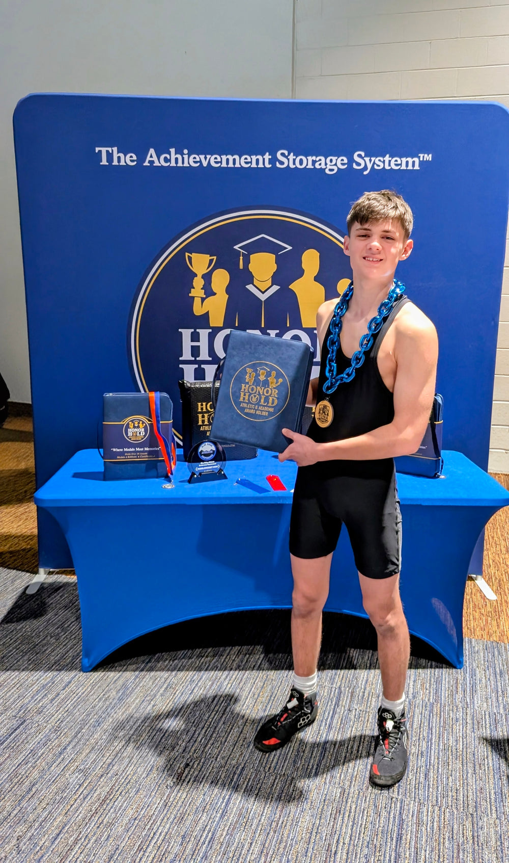Young achiever holding an Honor Hold binder