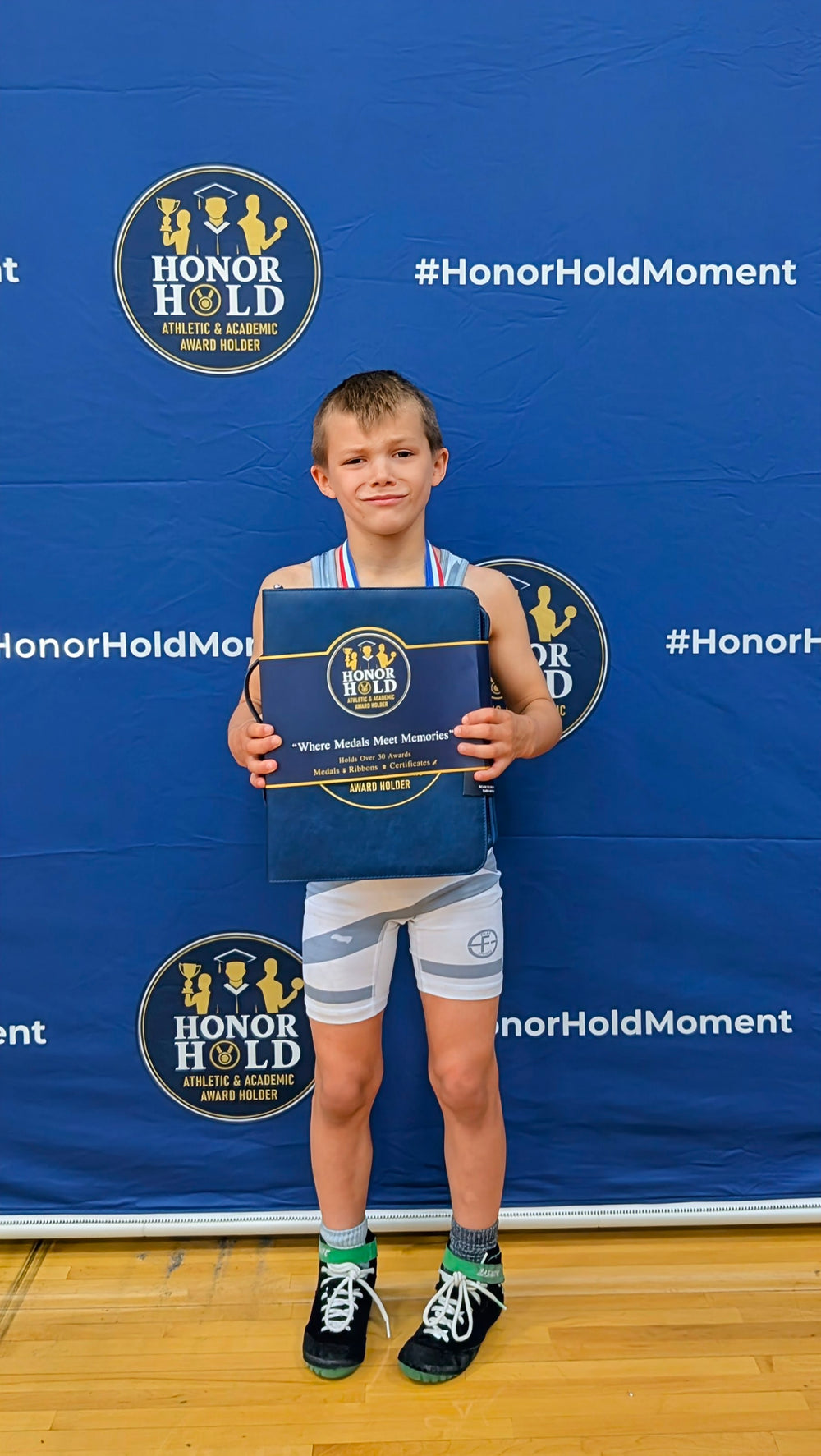 Student holding an Honor Hold award binder